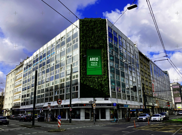 Location Düsseldorf. Multi-storey office glass building, at a large intersection with several cars.